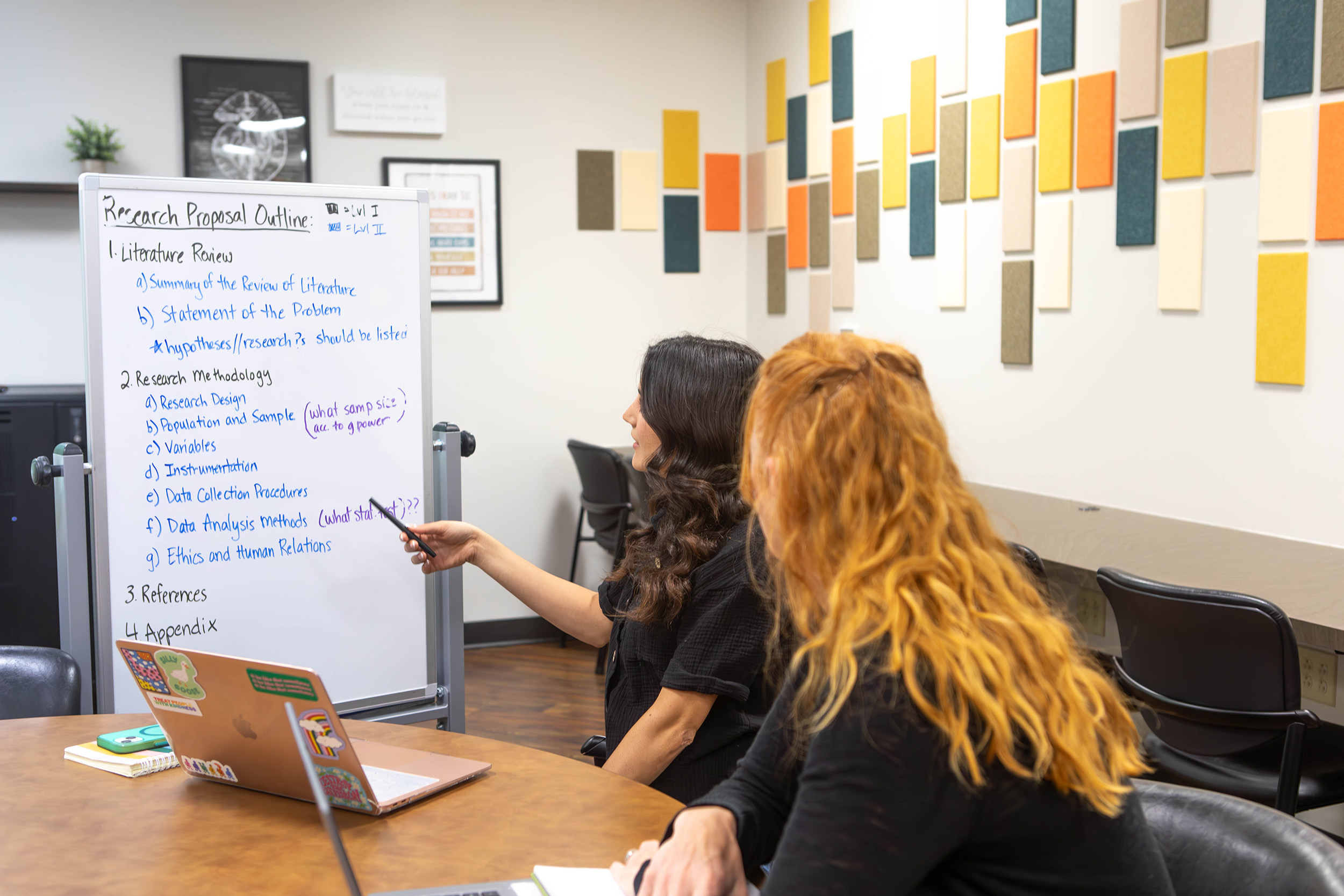 Students review a research proposal outline in the Center for Learning Innovation and Research.