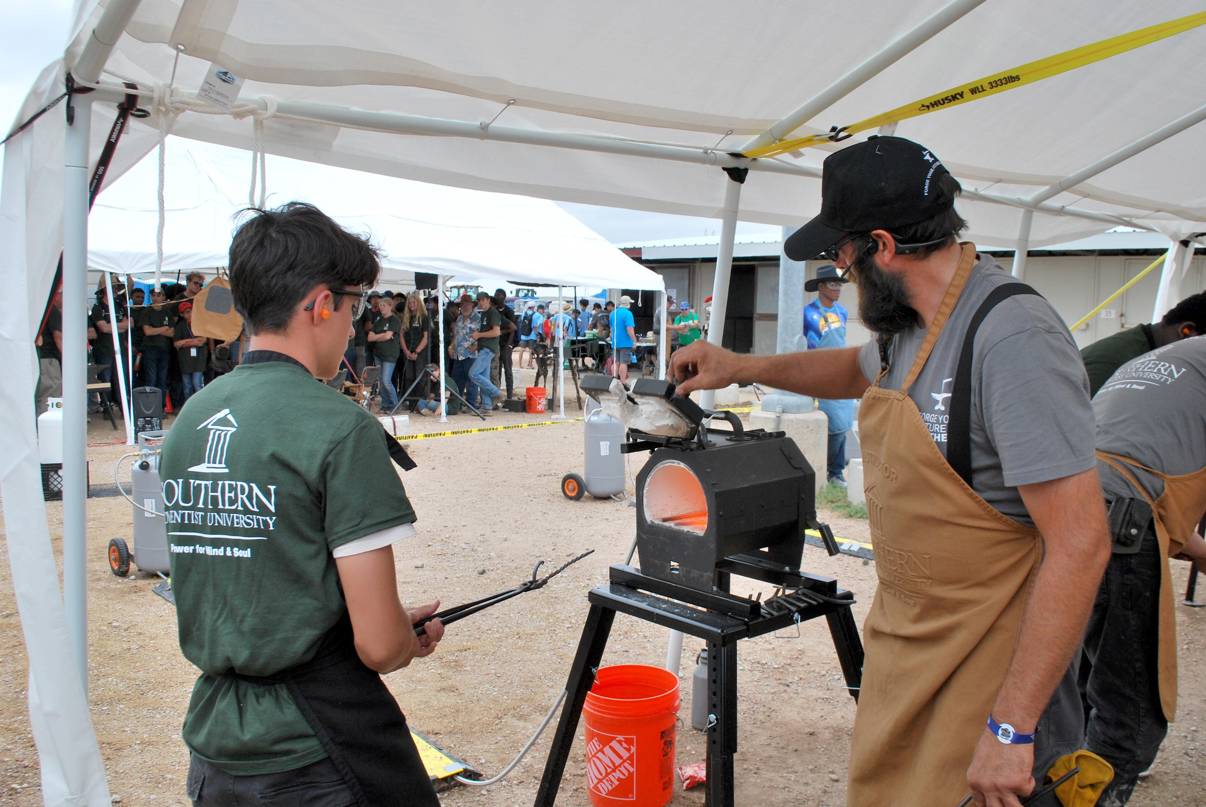 Southern Adventist University blacksmith station for a Pathfinder honor at the 2024 camporee in Wyoming