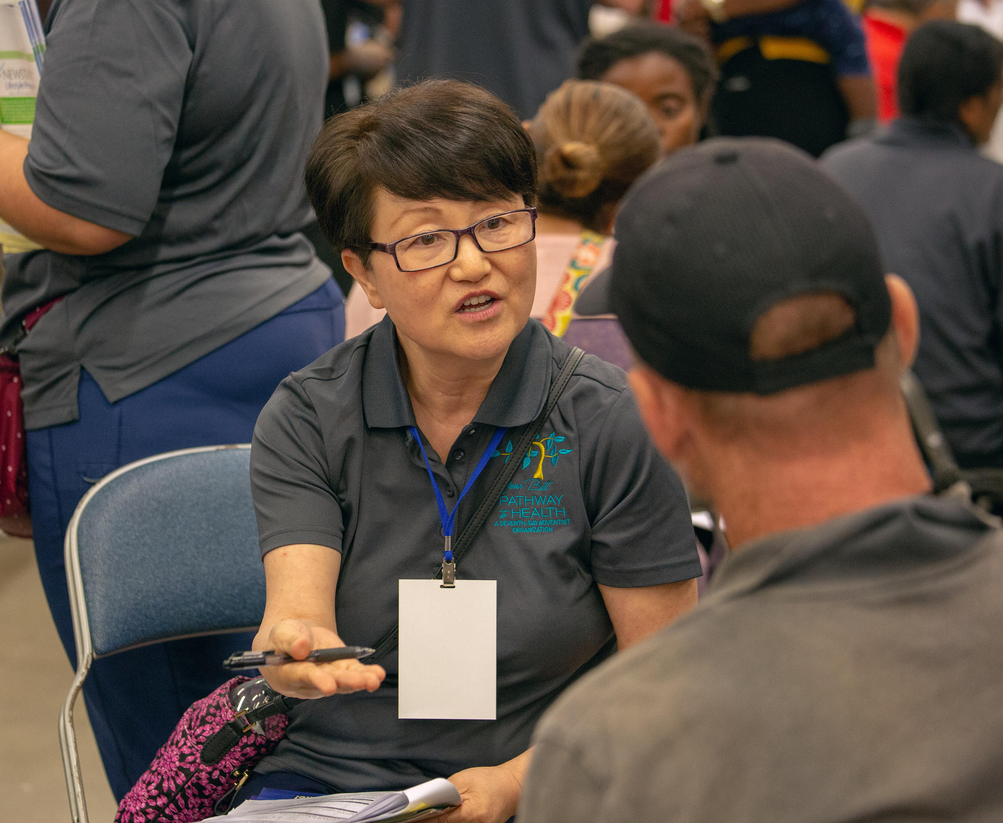 A volunteer shares information on a healthful lifestyle with a patient at the Sept. 19-21, 2018, mega clinic in Forth Worth, Texas. Photo by Pieter Damsteegt