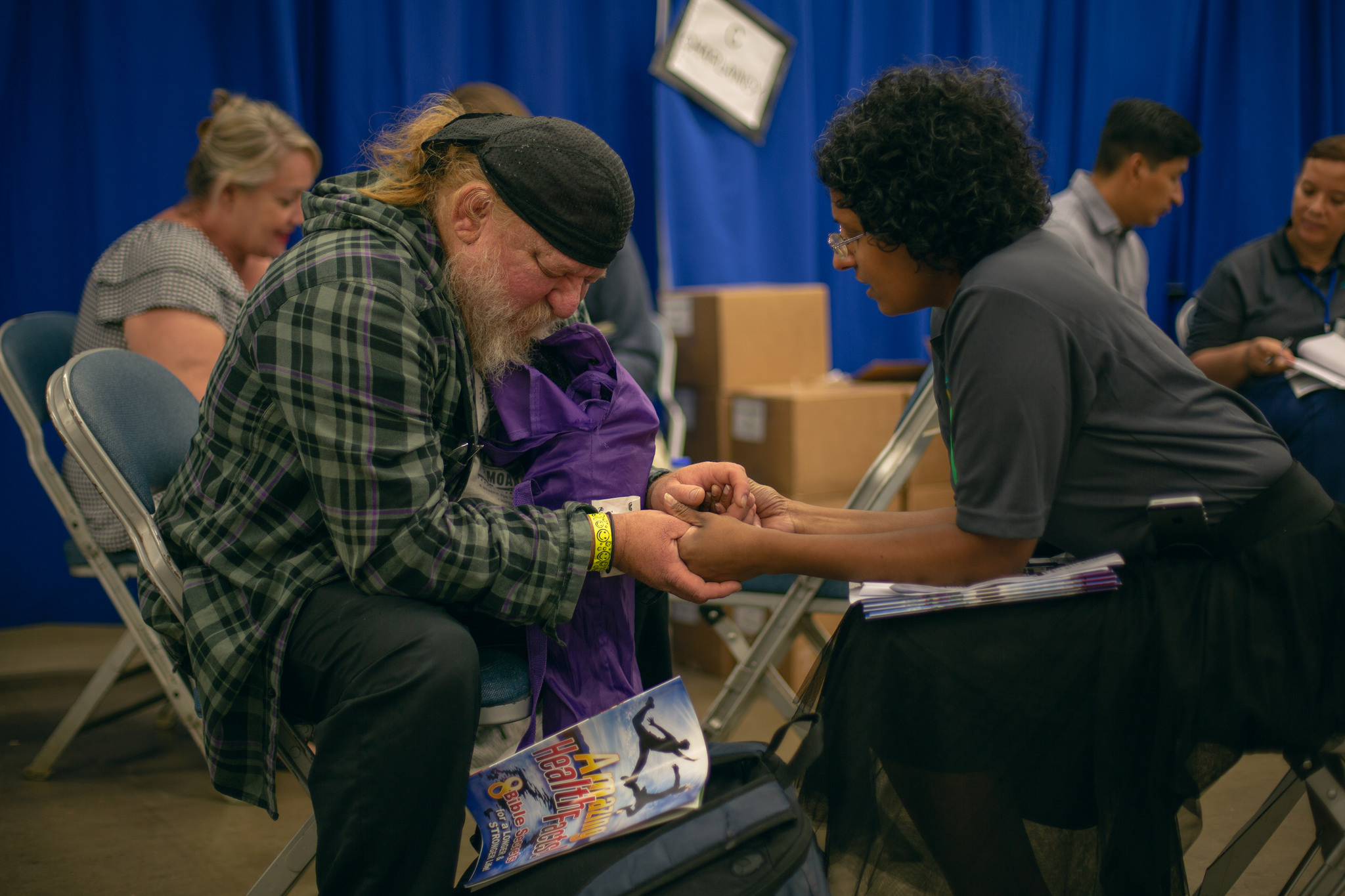 A patient and volunteer pray together during the Sept. 19-21, 2018, mega clinic in Forth Worth, Texas. Photo by Pieter Damsteegt
