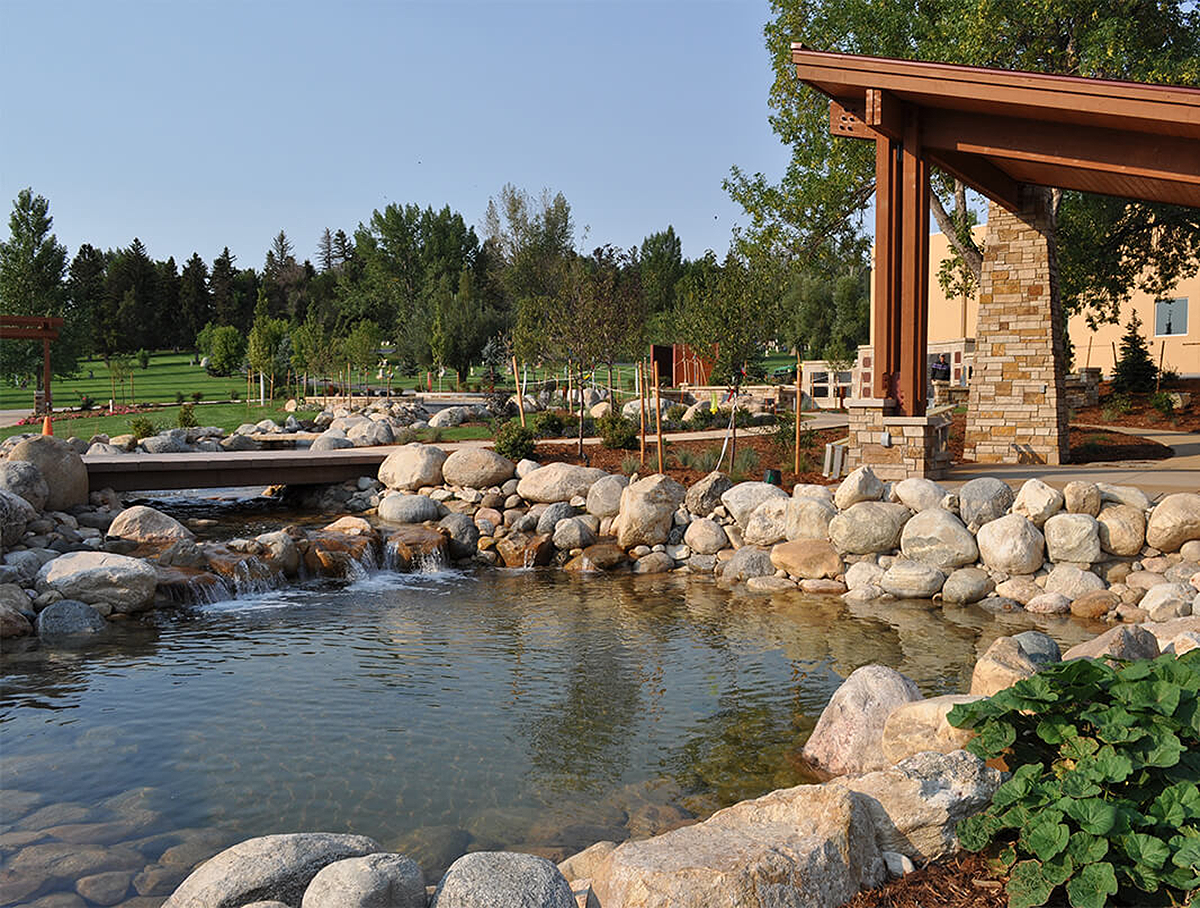 Photo of a man-made river surrounded by rocks and trees